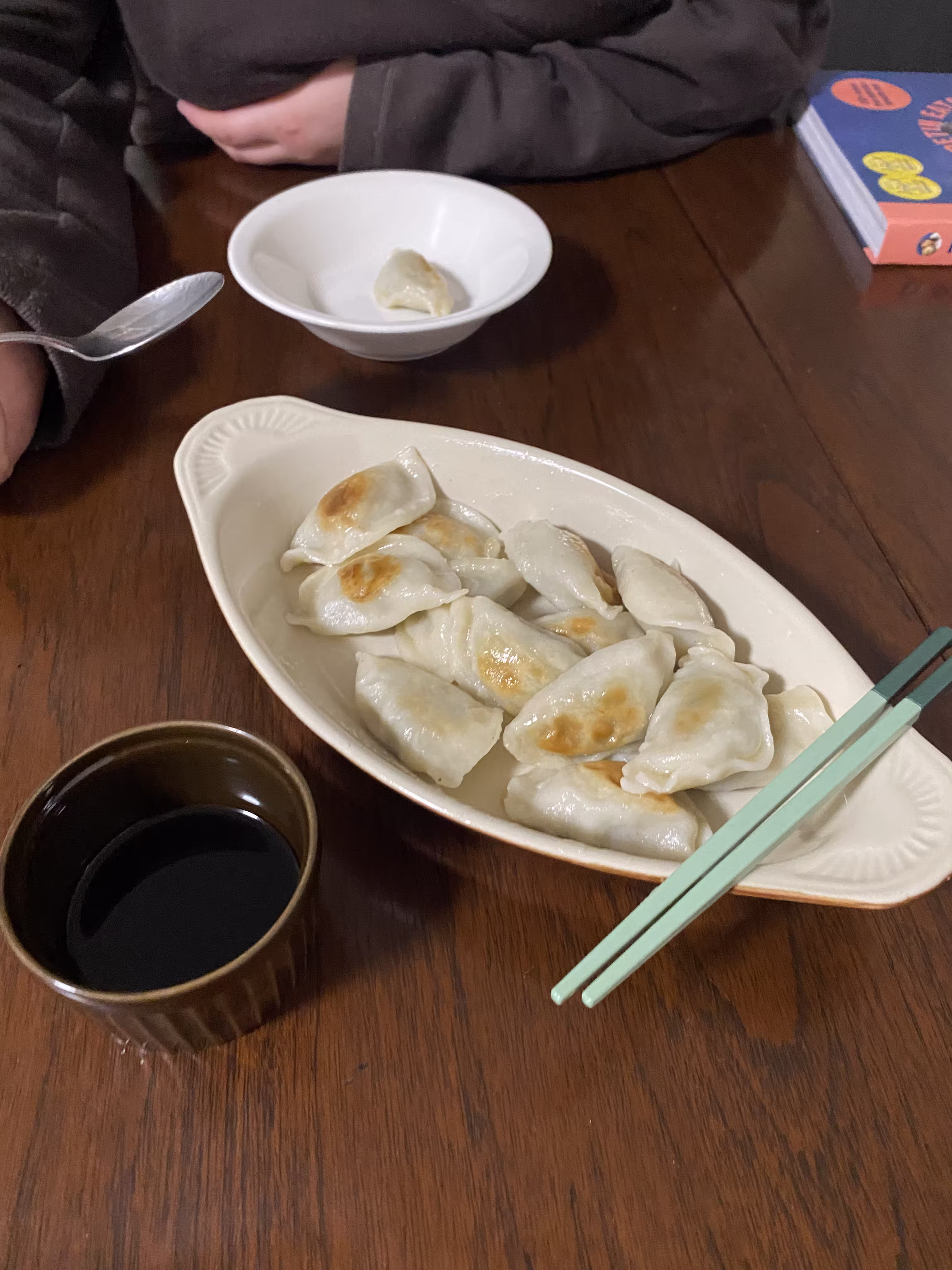Dumplings and soy sauce in bowls